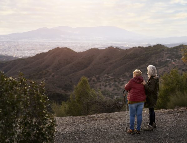 two-older-female-friends-enjoying-hike-together-nature